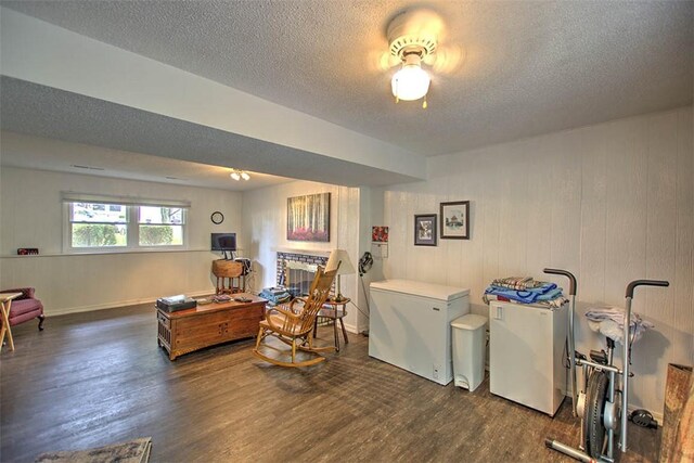 1065 S Wildwood Dr, Mt Zion, IL 62549 - sitting room with wood finished floors and a textured ceiling