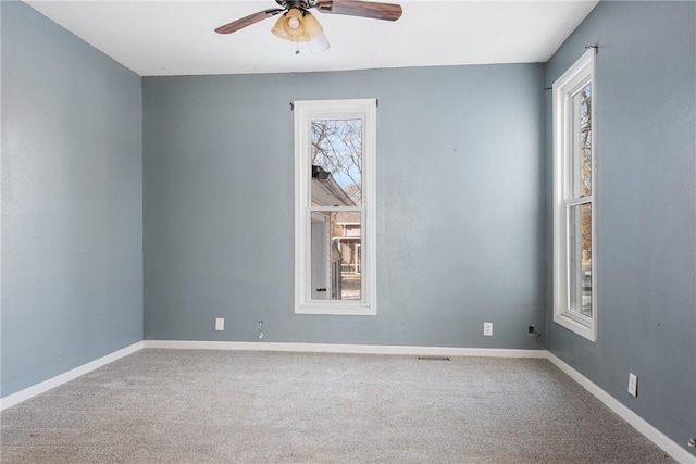 unfurnished room with carpet flooring and ceiling fan