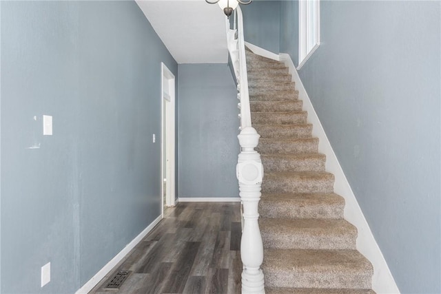 staircase with wood-type flooring