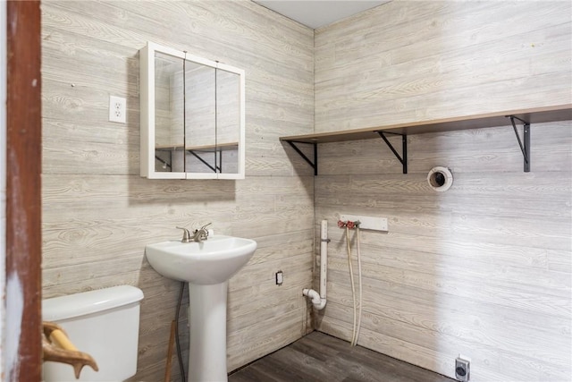 bathroom featuring wood-type flooring, sink, and toilet