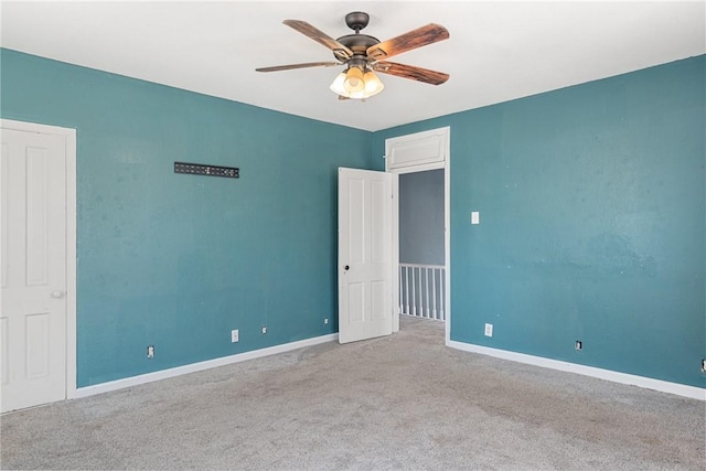 empty room with light colored carpet and ceiling fan