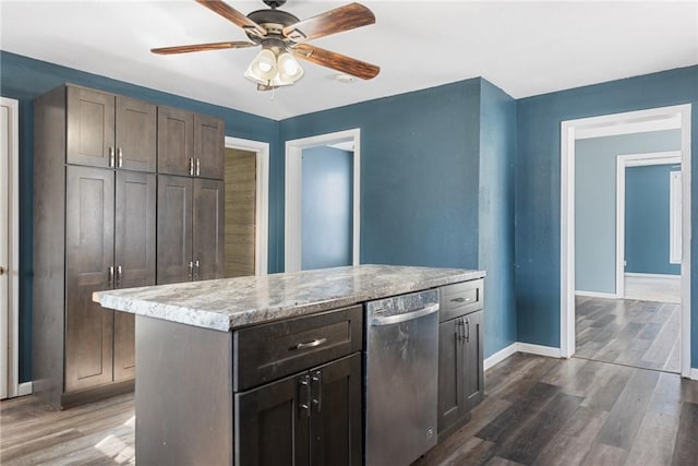 kitchen with a kitchen island, dark hardwood / wood-style flooring, stainless steel dishwasher, ceiling fan, and dark brown cabinets