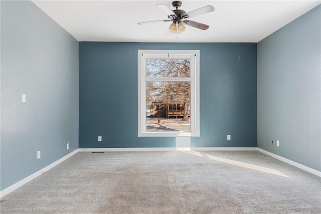 empty room with ceiling fan and carpet flooring