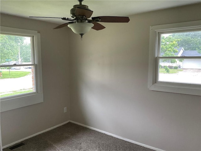 1696 W Evandale Dr, Decatur, IL 62526 - unfurnished room featuring plenty of natural light, dark colored carpet, and a ceiling fan