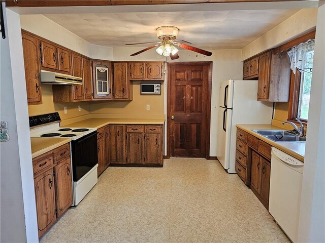 202 E Madison St, Toledo, IL 62468 - kitchen featuring white appliances, a sink, under cabinet range hood, a ceiling fan, and light floors