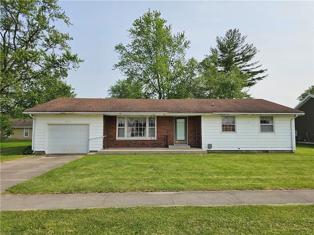 202 E Madison St, Toledo, IL 62468 - ranch-style house with a garage, concrete driveway, and a front yard