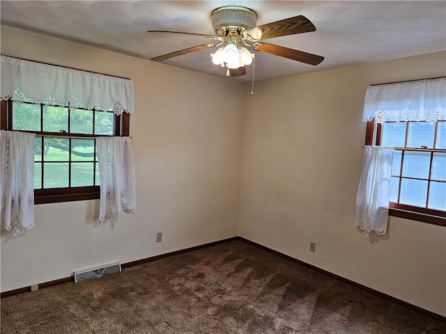 202 E Madison St, Toledo, IL 62468 - empty room with dark carpet, ceiling fan, and baseboards