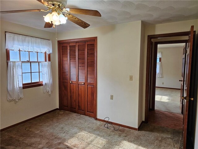 202 E Madison St, Toledo, IL 62468 - unfurnished bedroom featuring carpet, a closet, baseboards, and a ceiling fan