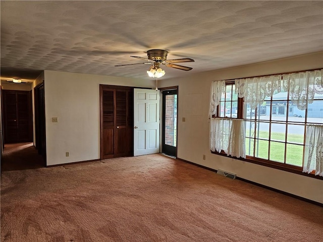 202 E Madison St, Toledo, IL 62468 - carpeted spare room featuring baseboards and ceiling fan
