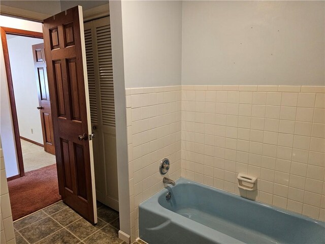 202 E Madison St, Toledo, IL 62468 - bathroom featuring a tub, tile patterned floors, and baseboards