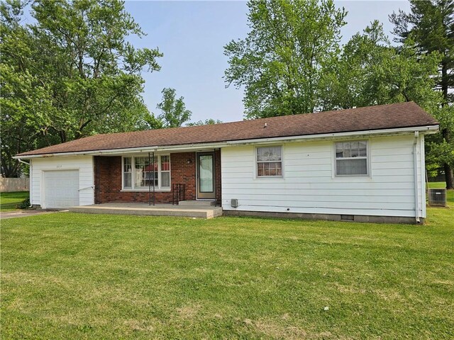 202 E Madison St, Toledo, IL 62468 - ranch-style home with central air condition unit, a garage, a front lawn, driveway, and covered porch