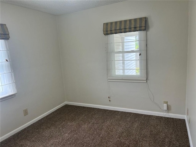 1413 13th St, Charleston, IL 61920 - carpeted empty room featuring baseboards