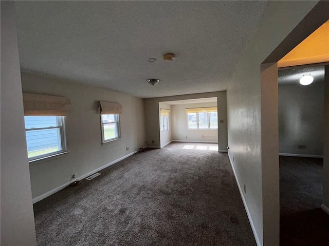 1413 13th St, Charleston, IL 61920 - carpeted spare room featuring a textured ceiling and a smoke detector