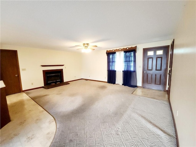 803 S Lafayette St, Newton, IL 62448 - unfurnished living room featuring ceiling fan, a glass covered fireplace, and carpet floors