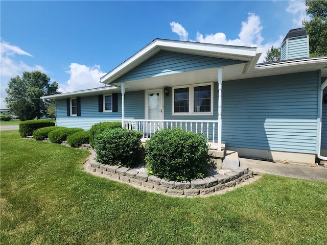 803 S Lafayette St, Newton, IL 62448 - view of front of house featuring a front lawn, a chimney, and a porch