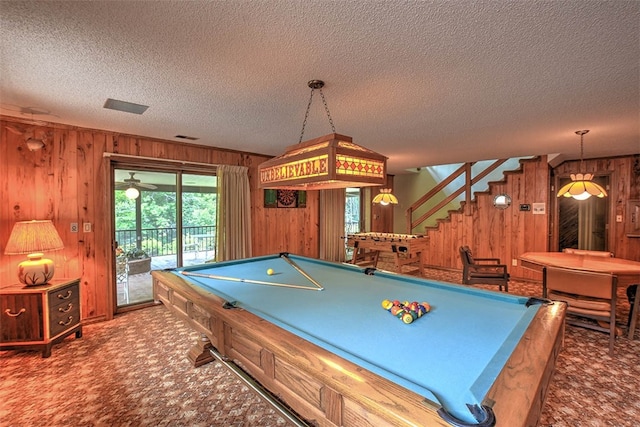 playroom featuring wood walls, carpet floors, a textured ceiling, and pool table