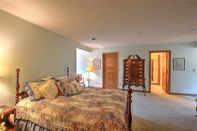 bedroom featuring light colored carpet and a textured ceiling