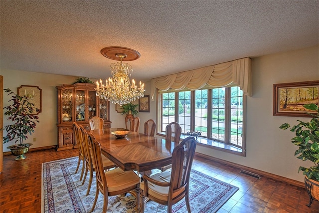 dining room with a textured ceiling and a chandelier