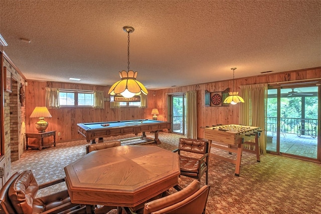 playroom featuring billiards, a textured ceiling, and wooden walls