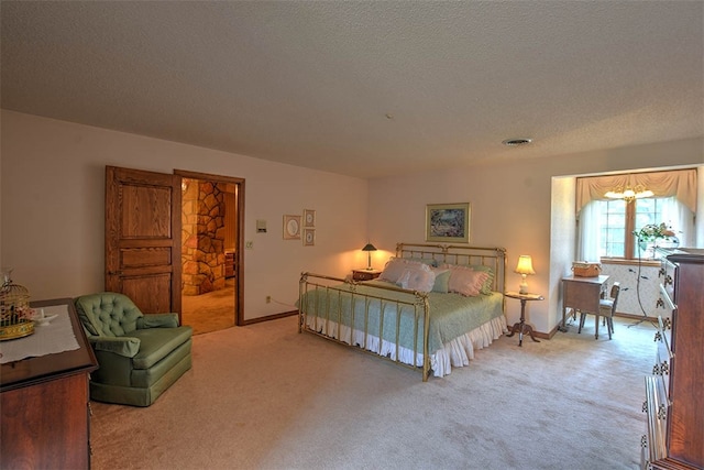 carpeted bedroom with a textured ceiling and an inviting chandelier