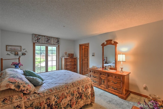 bedroom with light colored carpet and a textured ceiling