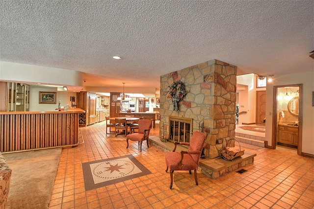 tiled living room with a fireplace and a textured ceiling