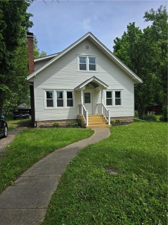 107 S Edwards St, Altamont, IL 62411 - bungalow-style house featuring a front lawn and a chimney