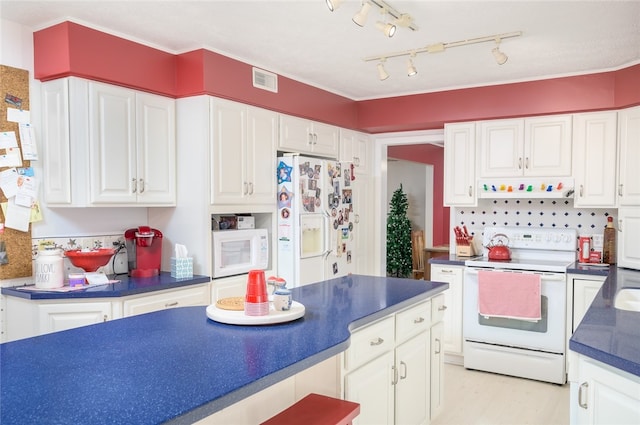 kitchen with white cabinetry, white appliances, and backsplash