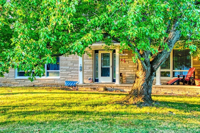 property entrance with a lawn