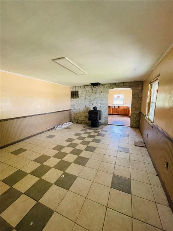 14014 E US Highway 40, Marshall, IL 62441 - unfurnished living room with a wood stove, light tile patterned floors, and wainscoting