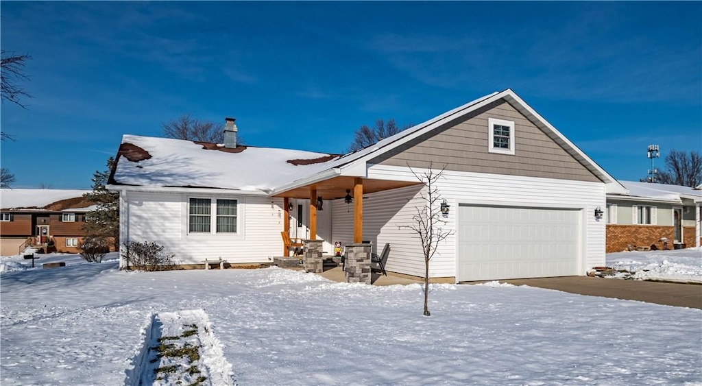 view of front of home with covered porch and a garage