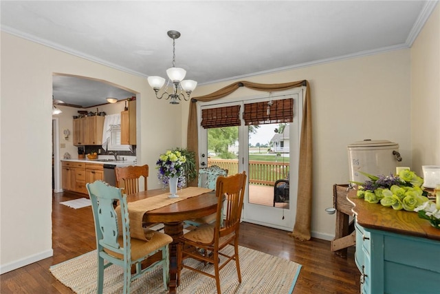 101 Willow Dr, Farina, IL 62838 - dining area with ornamental molding, dark wood-style flooring, a chandelier, and arched walkways