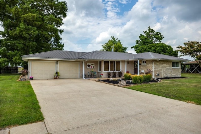 101 Willow Dr, Farina, IL 62838 - ranch-style home with an attached garage, a metal roof, a front lawn, and covered porch