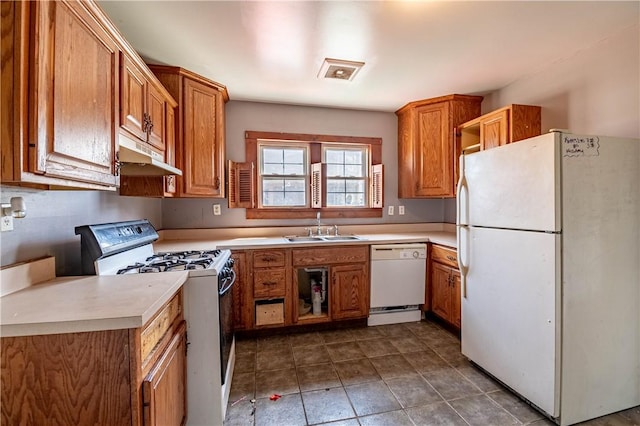 kitchen featuring brown cabinetry, open shelves, a sink, under cabinet range hood, and white appliances