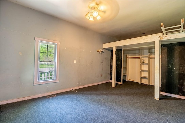 unfurnished bedroom with visible vents, carpet flooring, and two closets