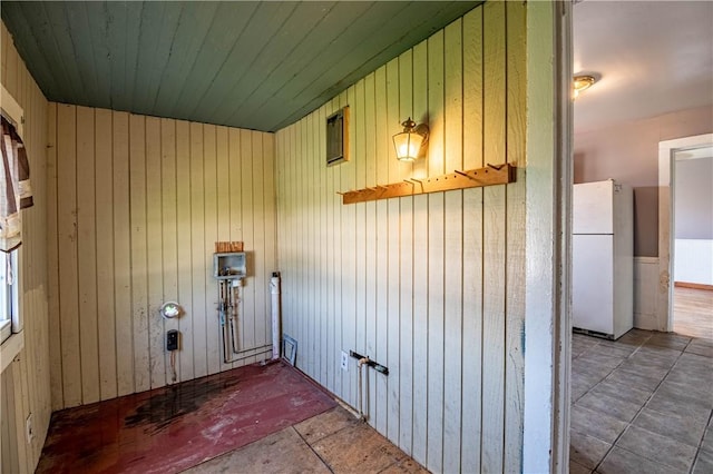 clothes washing area featuring wood walls