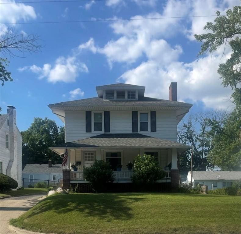 1300 E Lake Shore Dr, Decatur, IL 62521 - american foursquare style home featuring a porch, a front lawn, and a chimney