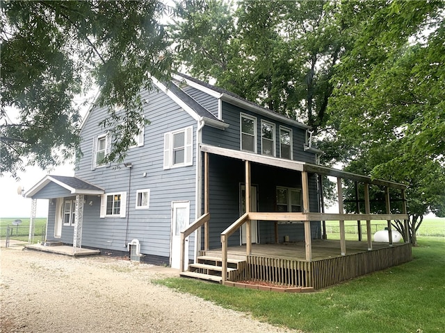 647 E 2100 N Rd, Assumption, IL 62510 - back of property with a lawn and a wooden deck