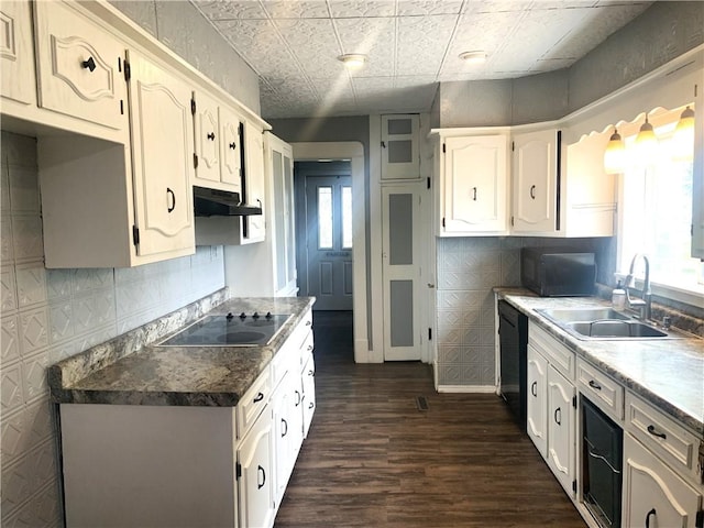 647 E 2100 N Rd, Assumption, IL 62510 - kitchen featuring under cabinet range hood, dark wood-style floors, black appliances, an ornate ceiling, and white cabinetry