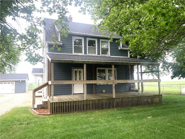 647 E 2100 N Rd, Assumption, IL 62510 - view of front of house featuring roof with shingles, a chimney, a deck, and an outbuilding