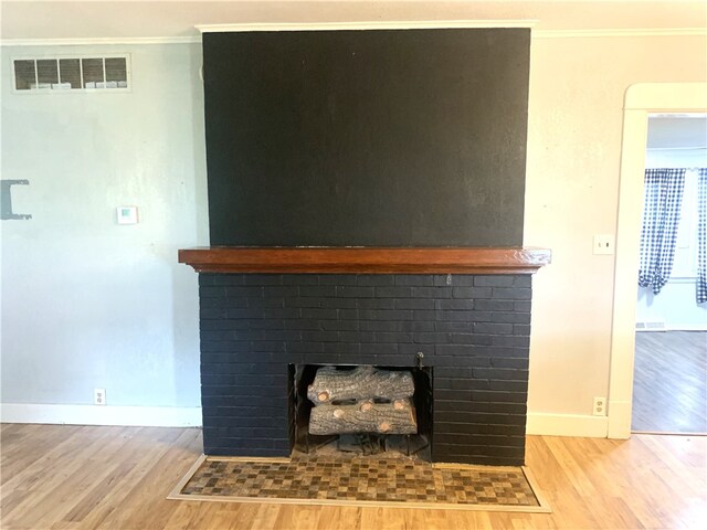 647 E 2100 N Rd, Assumption, IL 62510 - detailed view of wood finished floors, crown molding, and a fireplace