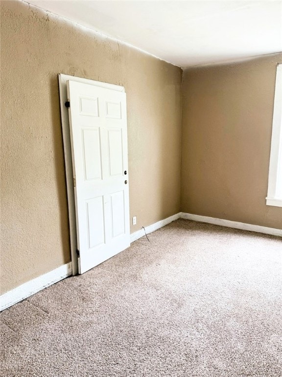 709 10th St, Charleston, IL 61920 - unfurnished room with carpet, a textured wall, and baseboards