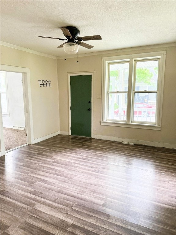 709 10th St, Charleston, IL 61920 - empty room featuring a textured ceiling, wood finished floors, ornamental molding, ceiling fan, and baseboards