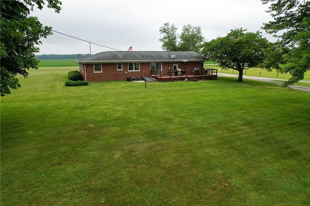 2251 W Stone Bluff Rd, Covington, IN 47932 - rear view of house featuring a deck, a yard, and brick siding