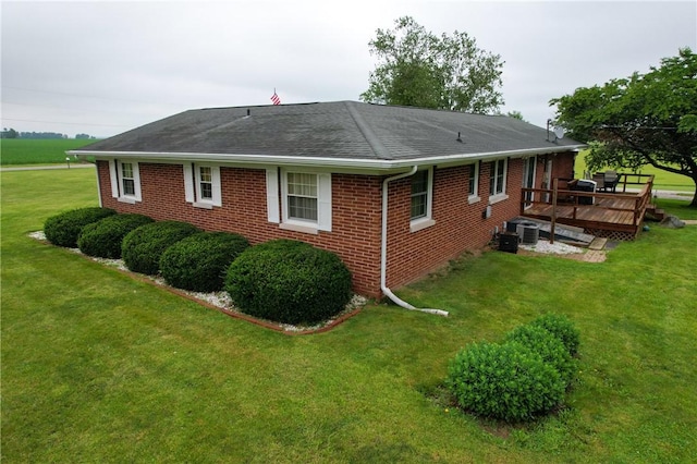 2251 W Stone Bluff Rd, Covington, IN 47932 - view of property exterior with a wooden deck, brick siding, a lawn, and a shingled roof