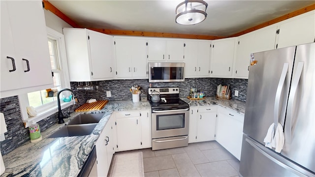2251 W Stone Bluff Rd, Covington, IN 47932 - kitchen with stainless steel appliances, light tile patterned floors, tasteful backsplash, and light stone countertops