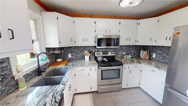 2251 W Stone Bluff Rd, Covington, IN 47932 - kitchen featuring stainless steel appliances, light tile patterned floors, backsplash, and white cabinetry