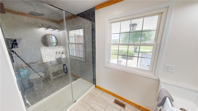 2251 W Stone Bluff Rd, Covington, IN 47932 - bathroom with a stall shower, tile patterned floors, and plenty of natural light