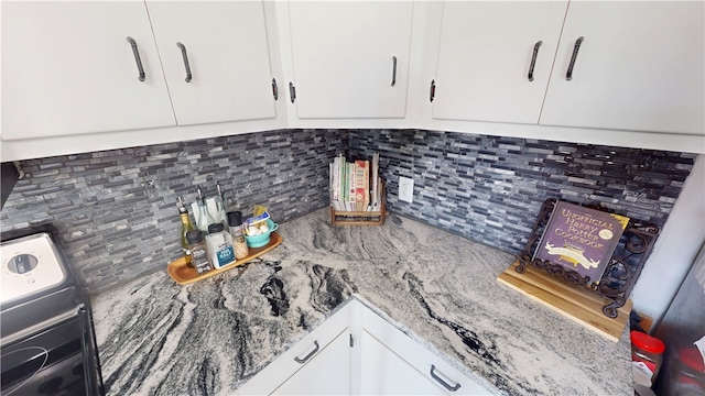 2251 W Stone Bluff Rd, Covington, IN 47932 - kitchen featuring backsplash, white cabinets, light stone counters, and washer / dryer