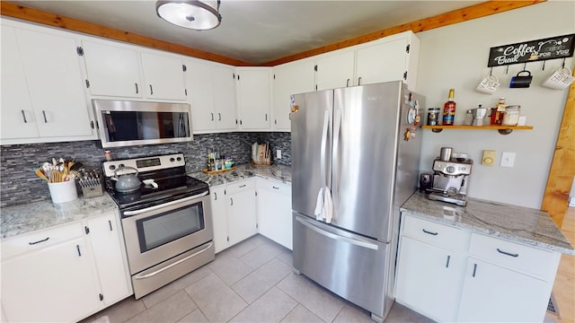 2251 W Stone Bluff Rd, Covington, IN 47932 - kitchen with appliances with stainless steel finishes, backsplash, light tile patterned flooring, and light stone countertops